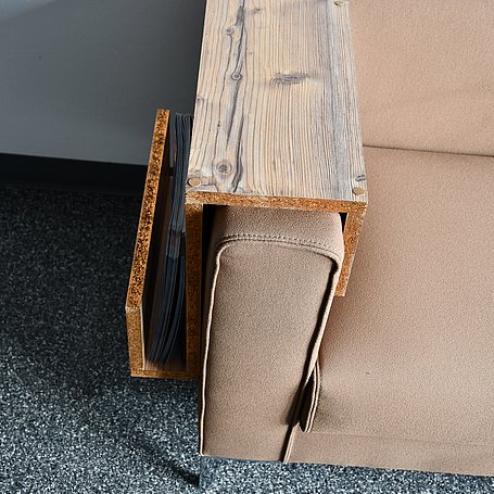 Angebrachter Couchtisch für die Armlehne aus Holz am braunen Sofa