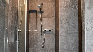 Dusche mit grauen Fliesen für das Projekt Injoy